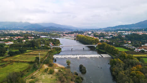 stunning aerial 4k drone footage of a village - ponte de lima and its two bridges crossing over the lima river