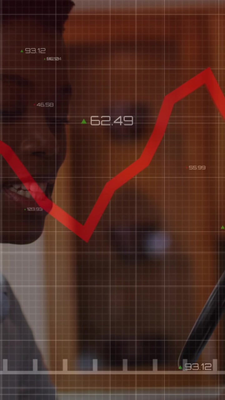 A black woman is singing into a microphone while wearing headphones at home