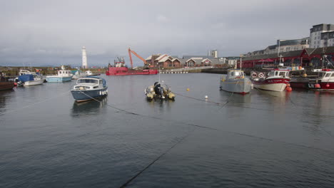 boote im hafen von newhaven bei flut an einem bewölkten tag in edinburgh, schottland, großbritannien