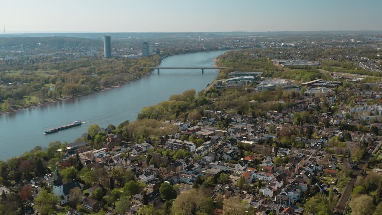 Drone - Aerial panorama shot of bonn with the konrad adenauer bridge, the river rhine with a ship, the Kameha Grand hotel and the post tower 30p