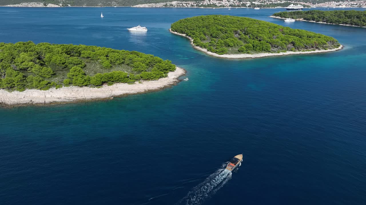 Motorboat Sailing Towards Hvar City - Pakleni Islands Aerial Tilt Down
