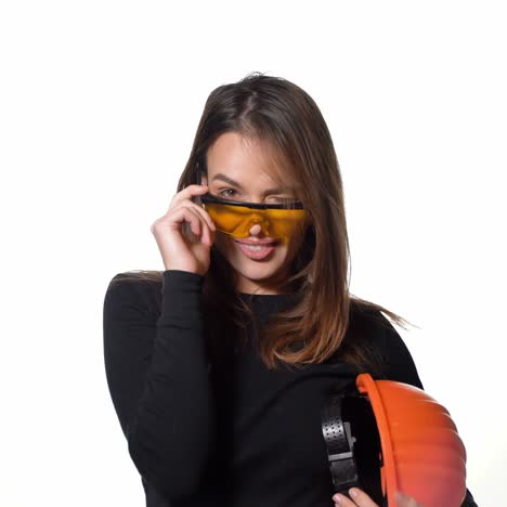 female construction worker. woman wearing protective helmet. positive human emotions. attractive young girl on white background.