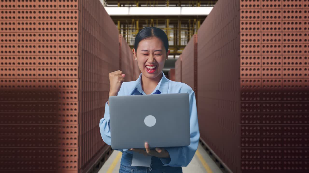 Woman Celebrating Success in a Brick Warehouse