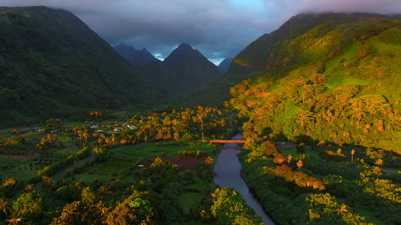 Vallee de Tautira Bay River village Tahiti island French Polynesia aerial drone golden morning sunrise towering jagged mountain peaks valley Teahupoo Mont Rauiri Aorai Taiarapu Taravao backwards