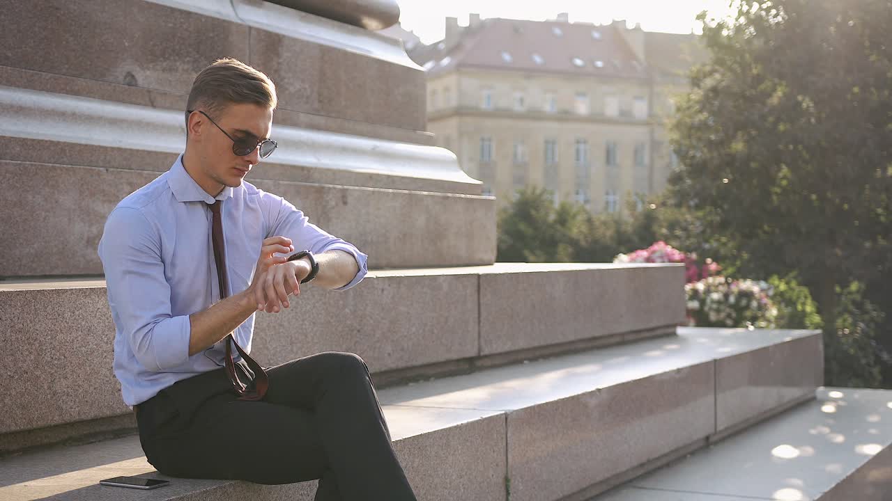 Man checking his smartwatch in the city