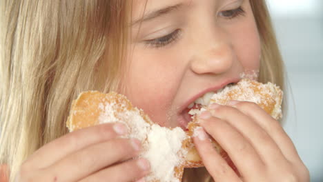 close up of girl eating sugary donut