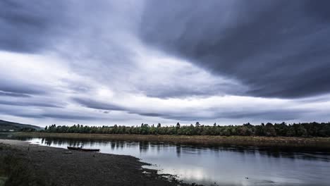 gray gloomy clouds flowing over the namsen river