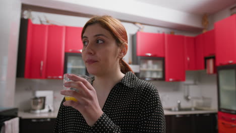 woman drinks fresh orange juice in the evening for vitamins