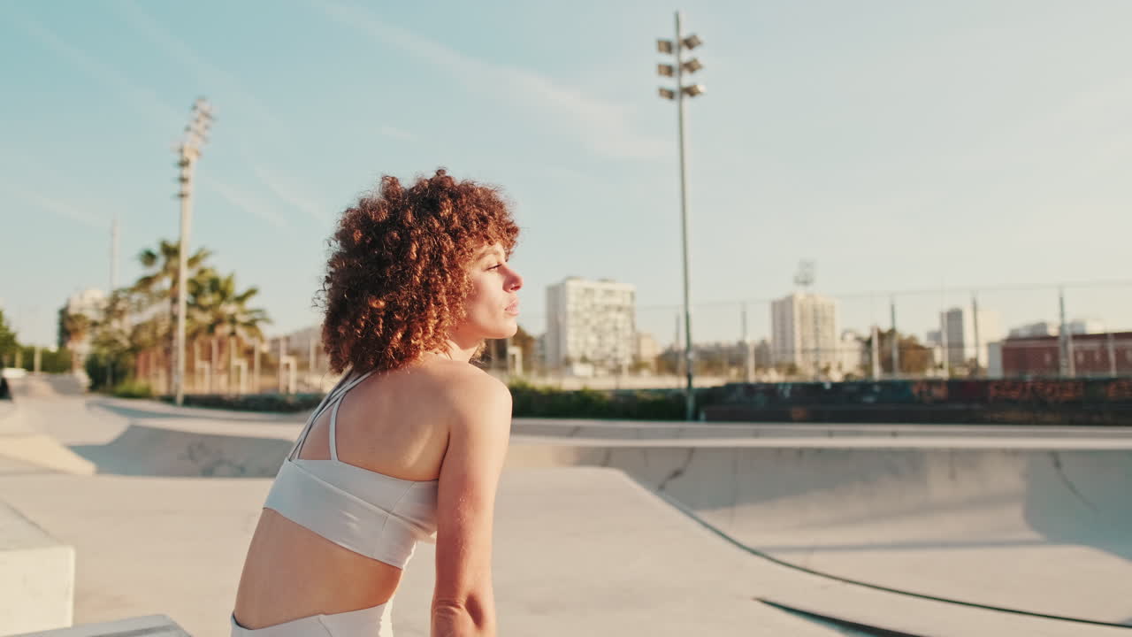 Fitness Woman Taking A Break At Skate Park