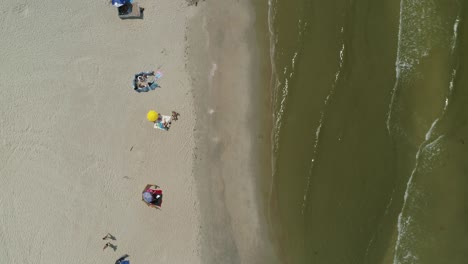 People-on-beach-of-Baltic-sea-coast-bath-and-sunbathe