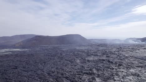 flying over steaming lava fields with sulfur smoke rising from the ground - aerial drone shot