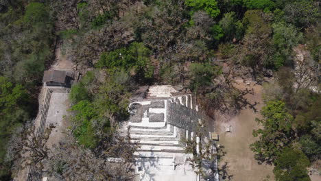 aerial looks down onto large step pyramid at ancient mayan copan ruins