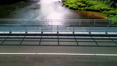 Aerial-zoom-out-shot-of-a-Bridge-over-a-river-viewed-from-above