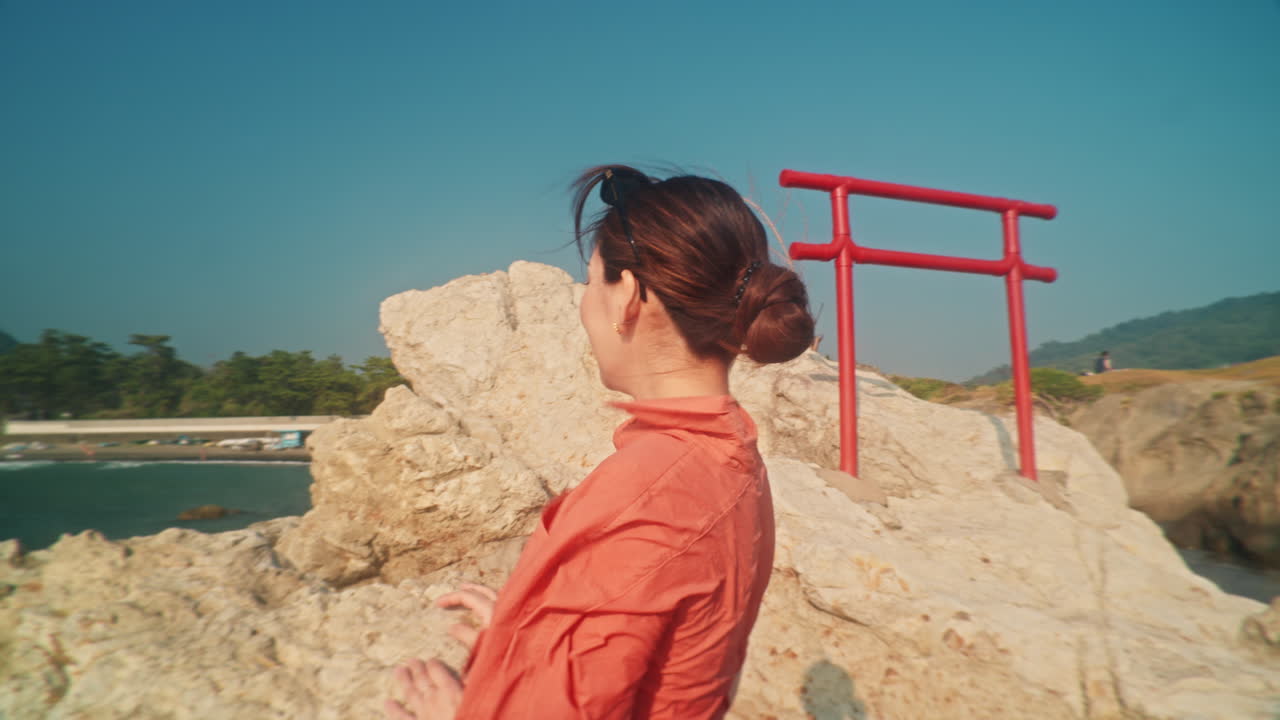 Woman overlooking beach and mountains