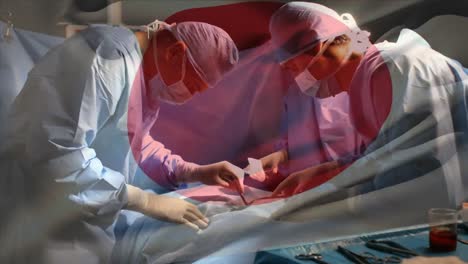 animation of flag of japan waving over surgeons in operating theatre