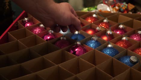 Person-Picking-Out-Ornaments-to-Place-on-the-Christmas-Tree