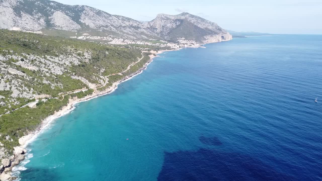 Drone flight northwards with spectacular Sardinian beaches and turquoise blue sea, sunny beautiful weather