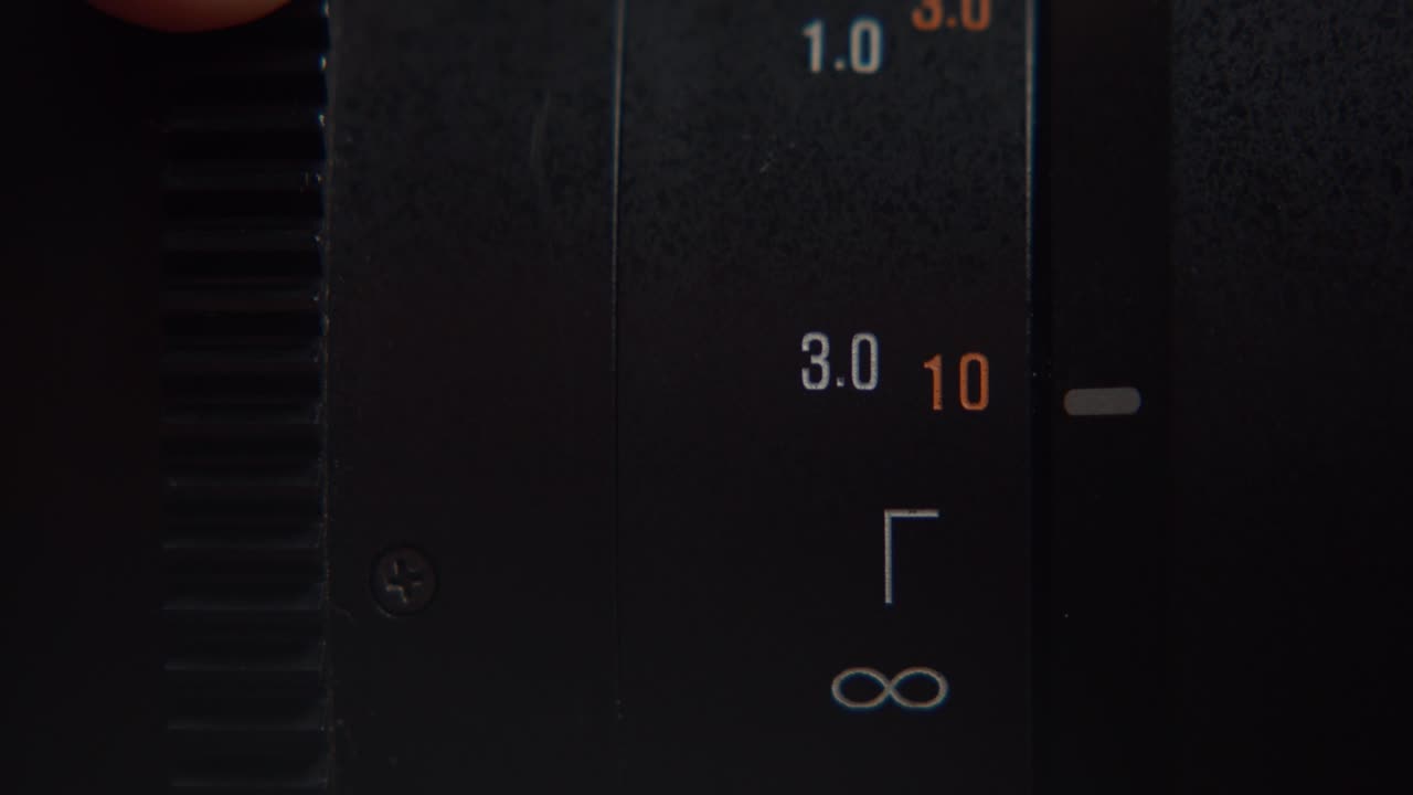 Rotating Focus Adjustment Ring And Focusing Distance Indicator Of A DSLR Camera Lens. macro