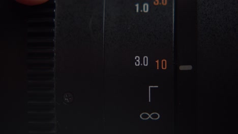 rotating focus adjustment ring and focusing distance indicator of a dslr camera lens. macro