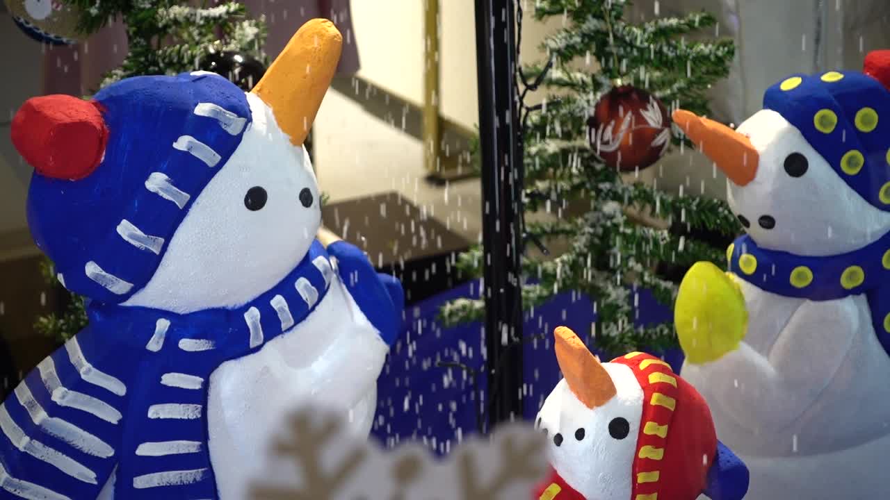 Snowmen in an inverted umbrella