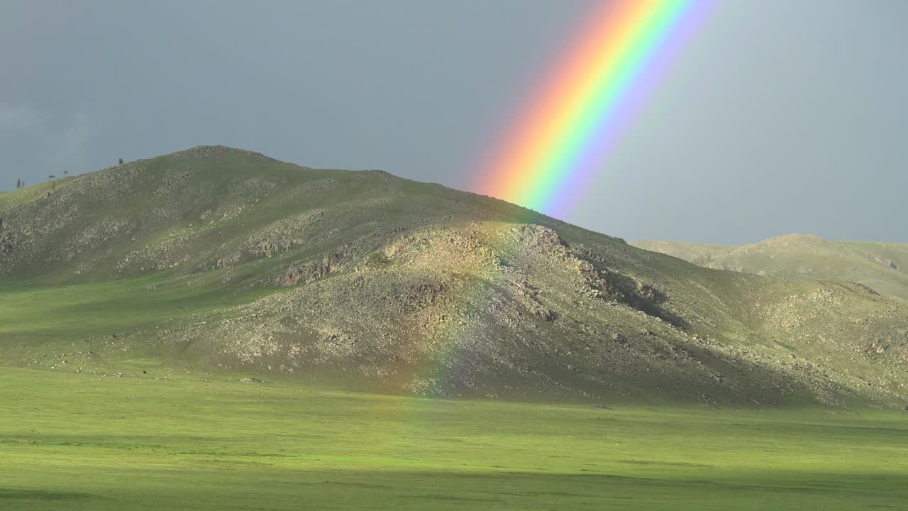 arco iris colorido en un vasto prado sin árboles