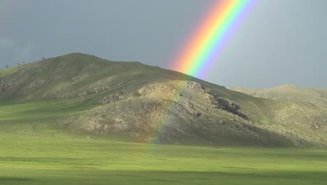 colorful rainbow in vast treeless meadow