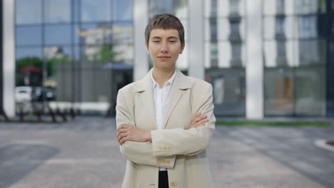 confident businesswoman in front of modern office building