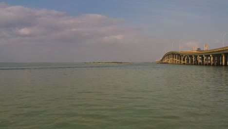 droning towards an island along a bridge in nueces bay texas