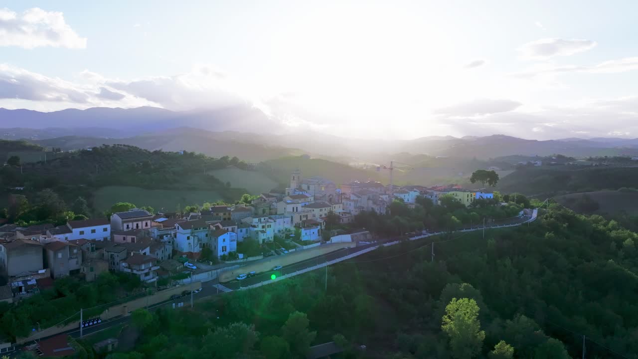 Stunning 4K drone footage of a scenic valley at sunset, with golden light reflecting on the camera