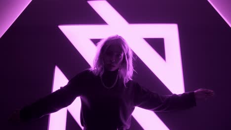 Black-African-girl-woman-female-dancing-with-neon-magenta-pink-lights-in-studio