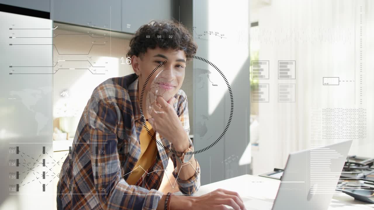 Male student focusing and typing on laptop in kitchen, HUD overlays appearing and analyzing data