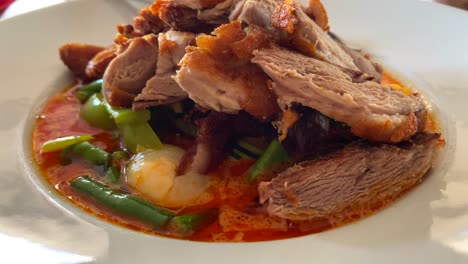 traditional thai red curry crispy duck dish with vegetables, authentic thai cuisine restaurant, 4k shot