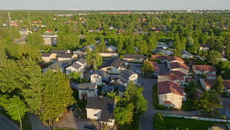 aerial: contemporary homes equipped with photovoltaic cells, summer evening