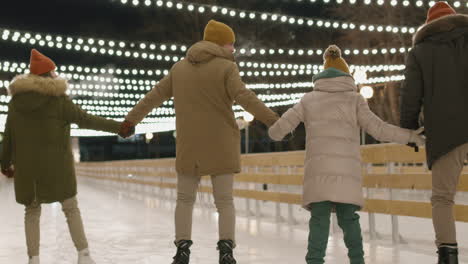 family ice skating at night