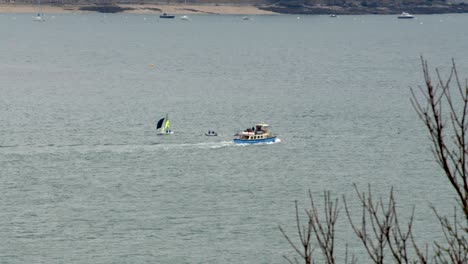 Tourist-boat-passing-small-sailboat-at-Falmouth