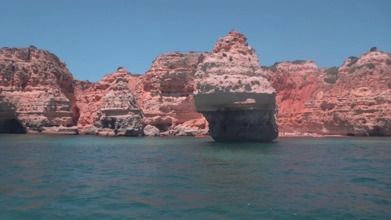 Rock Formations In The Distance Of The Sea