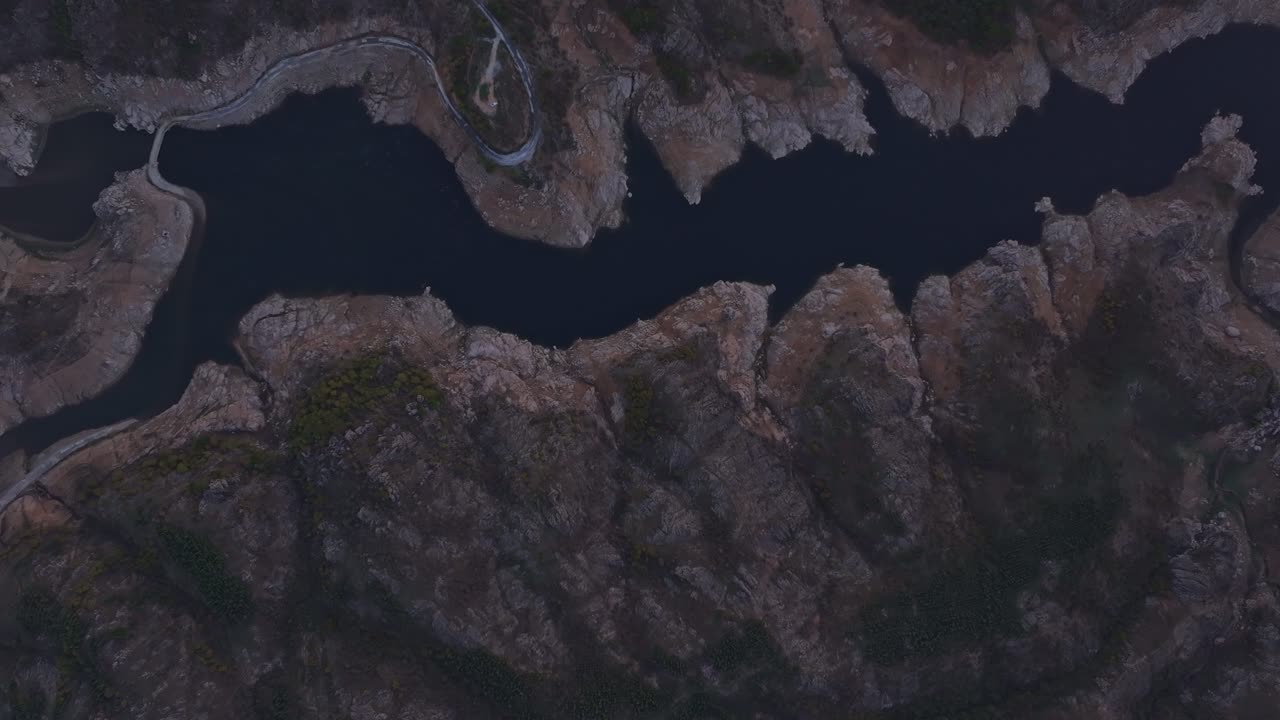 Serene lake reflecting soft sunrise in remote valley, Turkiye