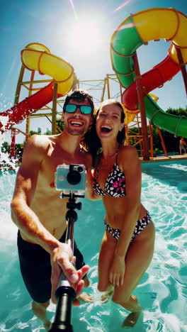 happy couple taking a selfie at a water park