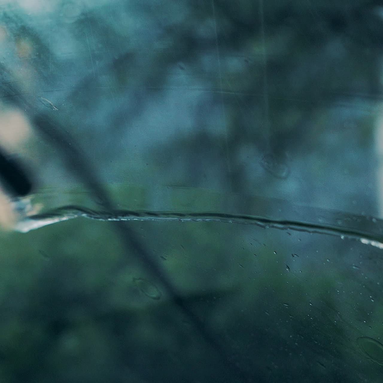 Rain on the windshield of the car. Water drop on glass