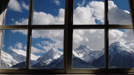 snowy mountain peaks view from a window
