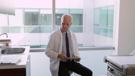 male doctor wearing white coat in exam room shot on r3d