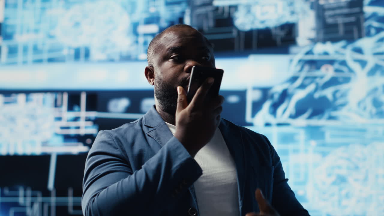 African american IT specialist calling a technician on his smartphone