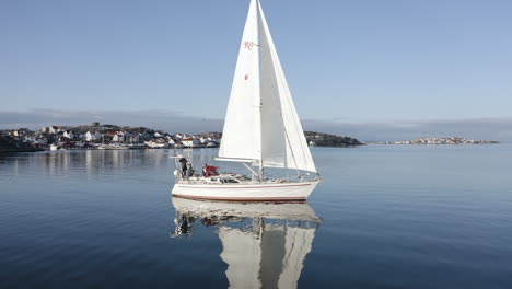 close-up shot of a big beautiful white sail boat outside a port at öckerö island municipality in gothenburg archipelago, sweden