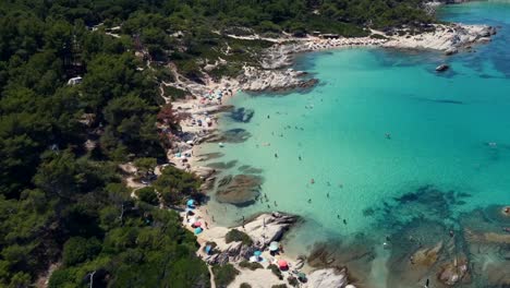 Crowded-Beach-Of-Kavourotrypes-During-Summer-In-Sithonia,-Greece