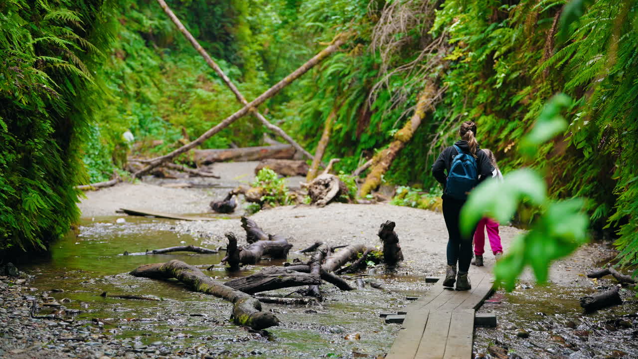 Mother and her children exploring the beauty of the forest