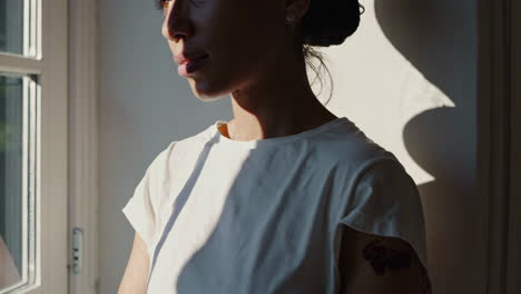 woman in profile by window
