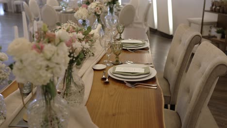 elegant long table with white flowers glassware and soft natural colors