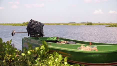 Medium-Shot-of-Green-Boat-in-Water