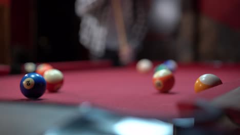 Happy-couple-playing-billiards-in-pub