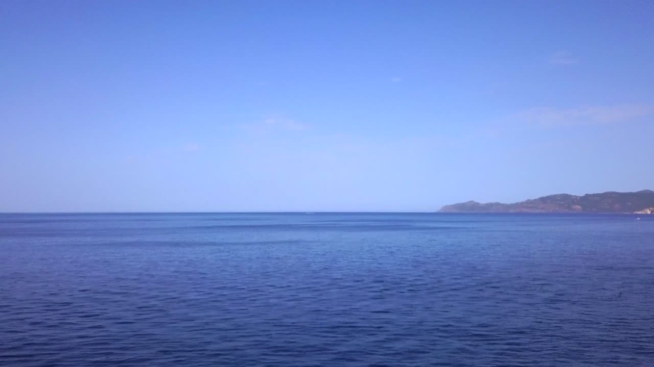 Drone Aerial shot flying over the natural swimming pool of Cane Malu in Sardinia, Italy. A wonderful typical mediterranean coastal landscape. the drone is flying towards the open sea